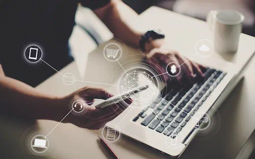 picture of man holding an iphone with icons showing online advertising and e-commerce